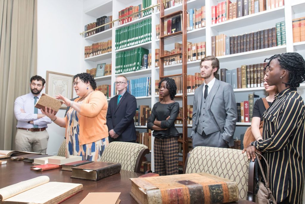 Library Director Miriam Child presenting rare law books to LLM students