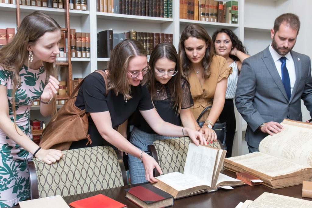 Students looking at old law books in the rare book room